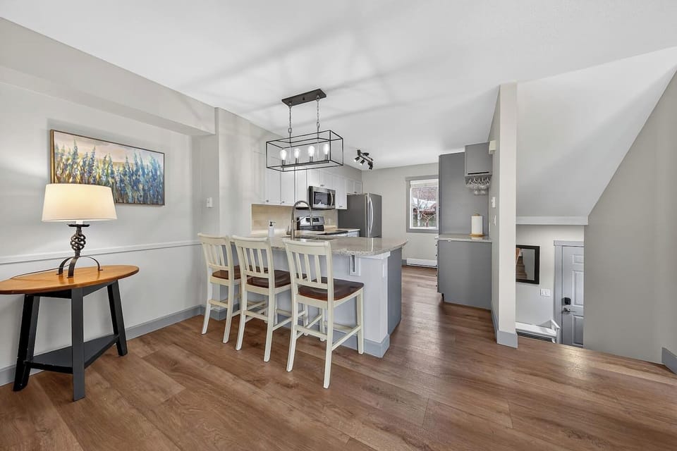 Dining area with seating for 6 at the table, and 3 at the island.