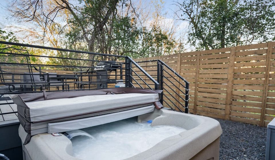 Soak away the day in your private hot tub, tucked behind a wooden privacy fence.