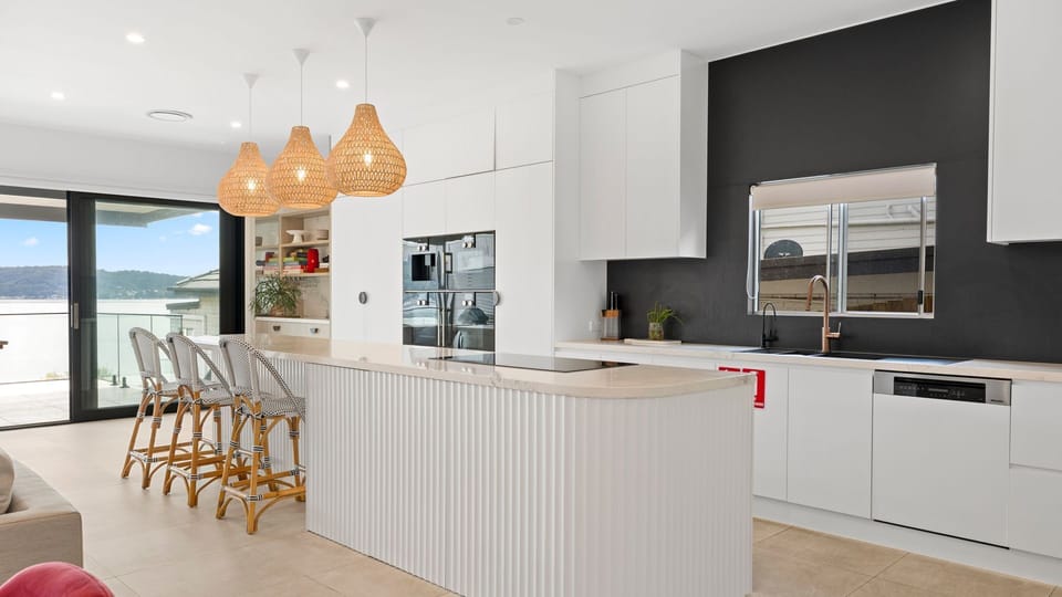 Sleek modern kitchen with high-end finishes and a breakfast bar perfect for casual dining