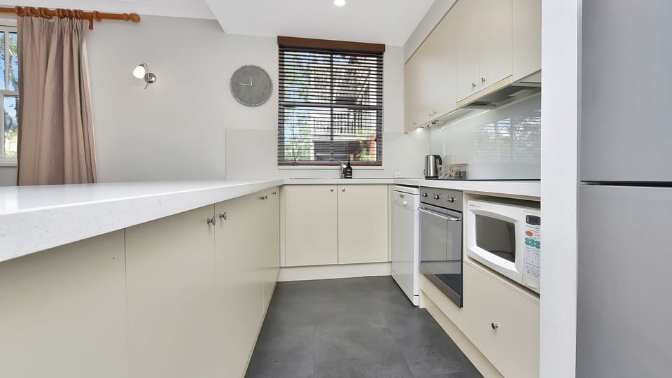 Bright, fully equipped kitchen with generous bench space