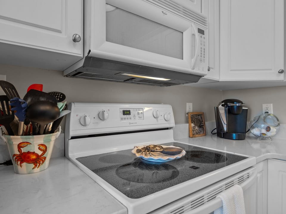 Your fully equipped kitchen features modern appliances and coastal charm, perfect for preparing memorable meals during your stay.