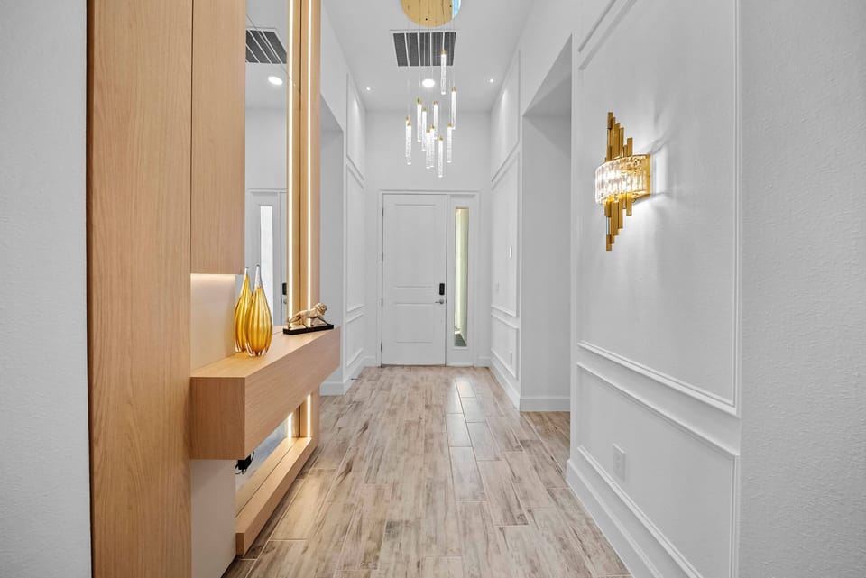 Step into a bright corridor that seamlessly blends style and comfort, featuring sleek wooden accents and elegant lighting fixtures. The warm tones of the flooring invite you to explore further into this beautifully designed space.