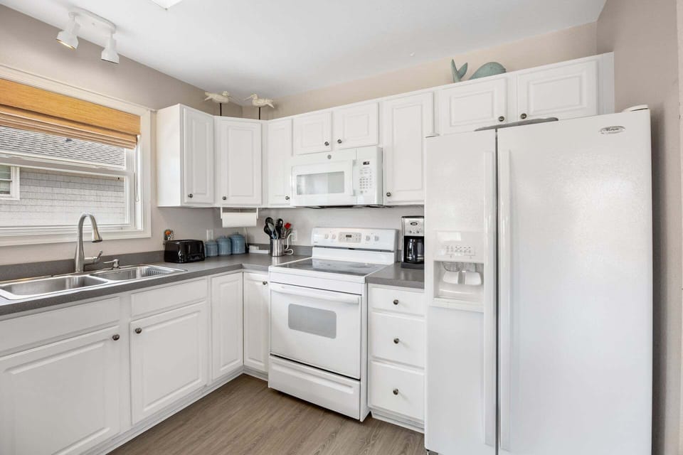 Prepare meals with ease in a well-stocked kitchen designed for convenience.