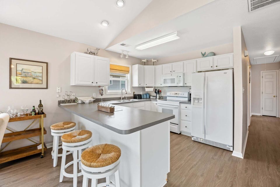 Prepare meals with ease in a well-stocked kitchen designed for convenience.