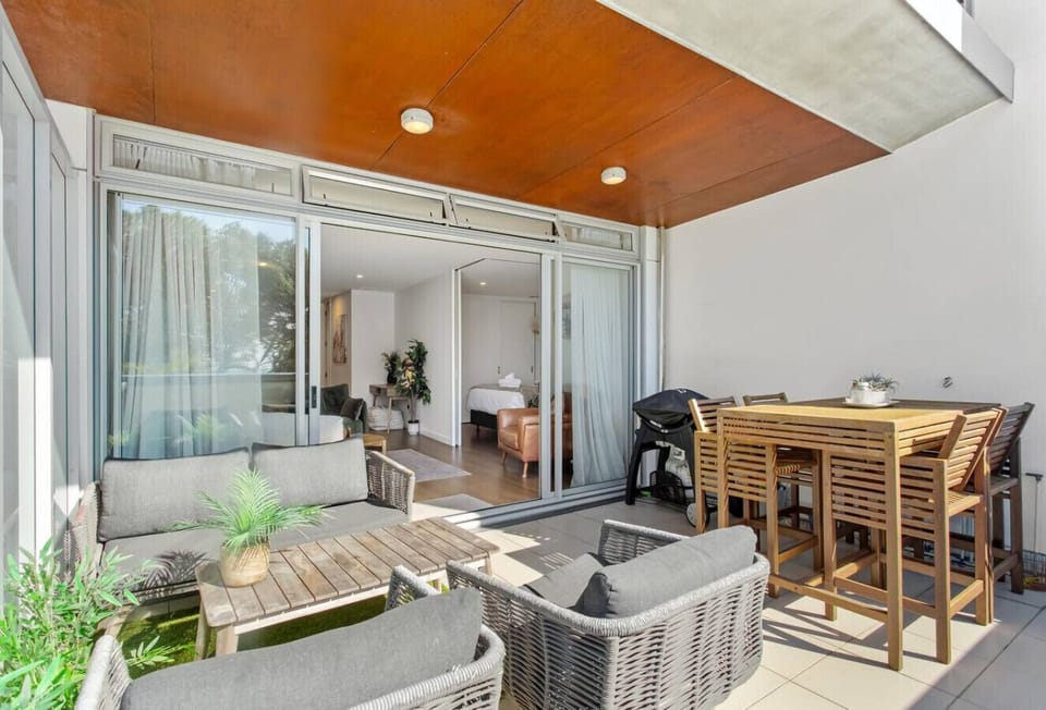 Sunny, private sea facing deck with outdoor furniture and BBQ
