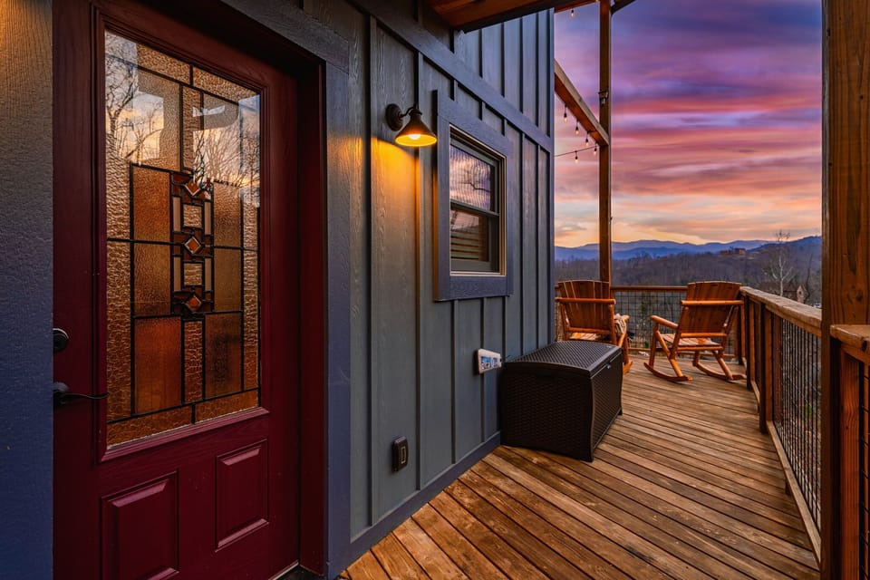 Step out the stained-glass door onto a deck with rockers and a ridge view.