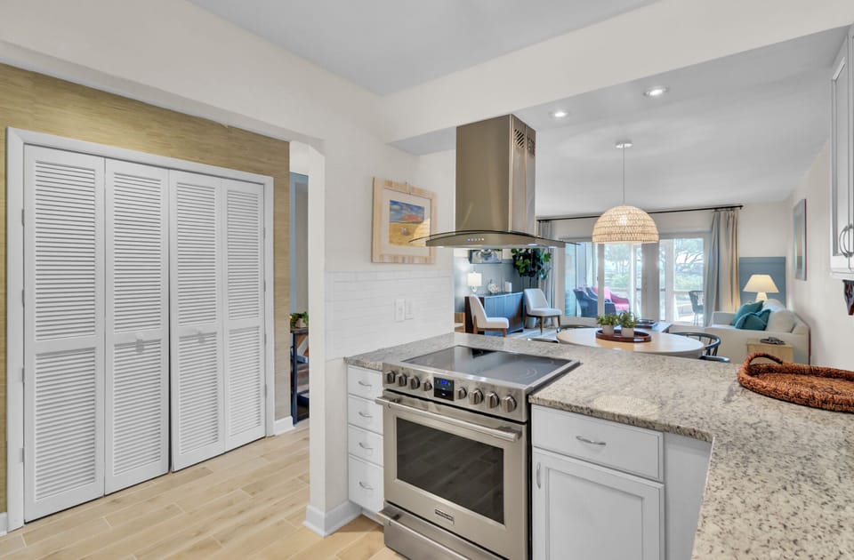Bright white kitchen with granite counters, subway tile, and everything set up for easy Charleston cooking.