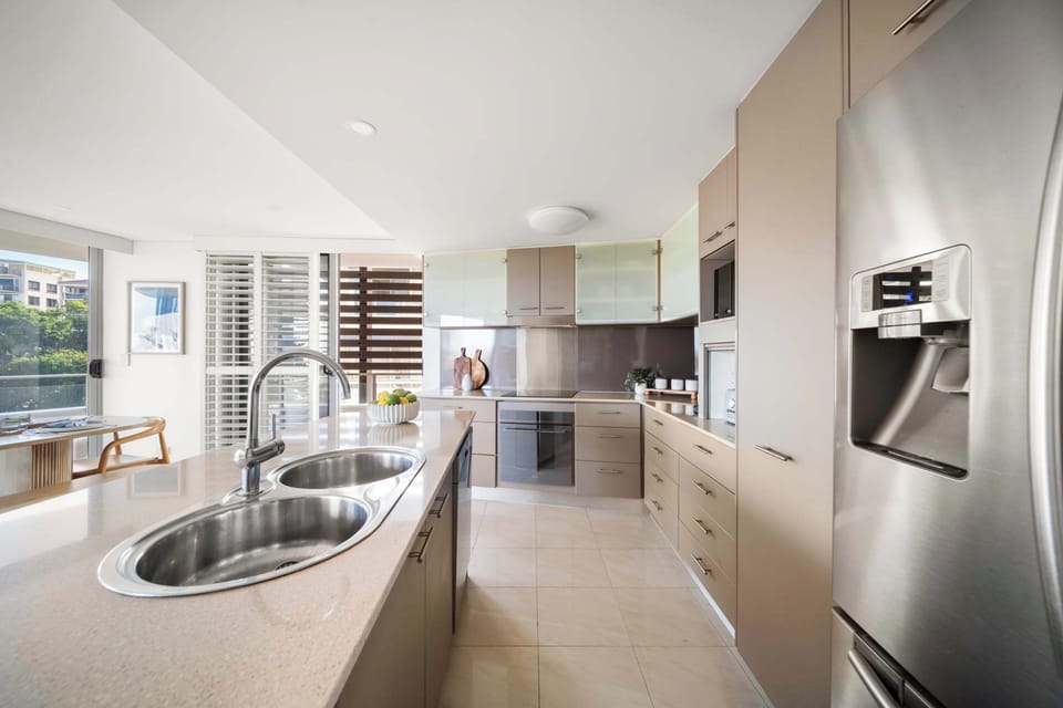 Sleek kitchen with generous bench space and modern appliances