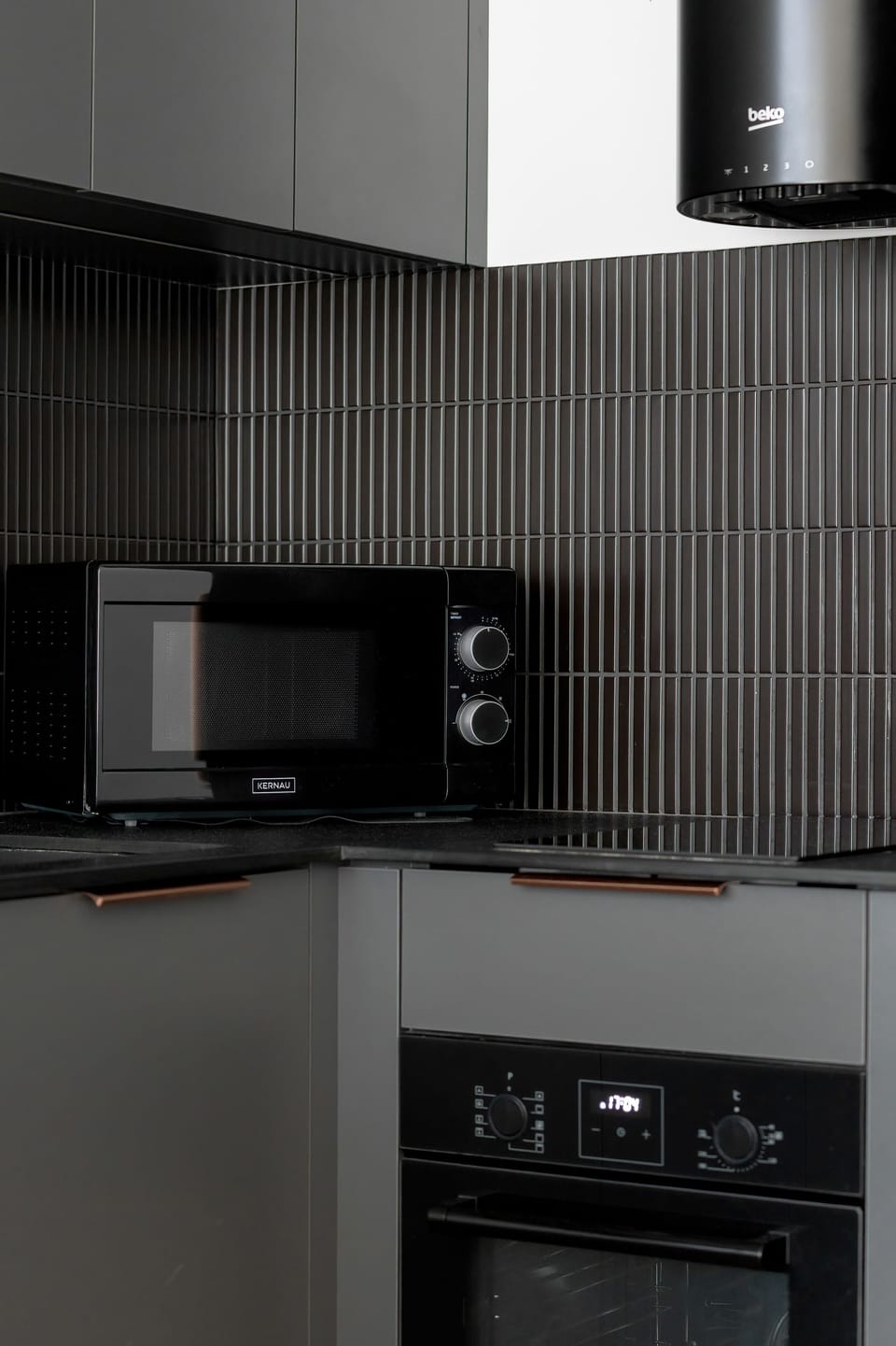 A kitchen countertop with appliances like a coffee machine and kettle. The space is practical and neatly arranged.