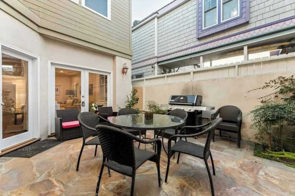 Enjoy alfresco dining in a comfortable patio setting with outdoor seating and barbecue area.