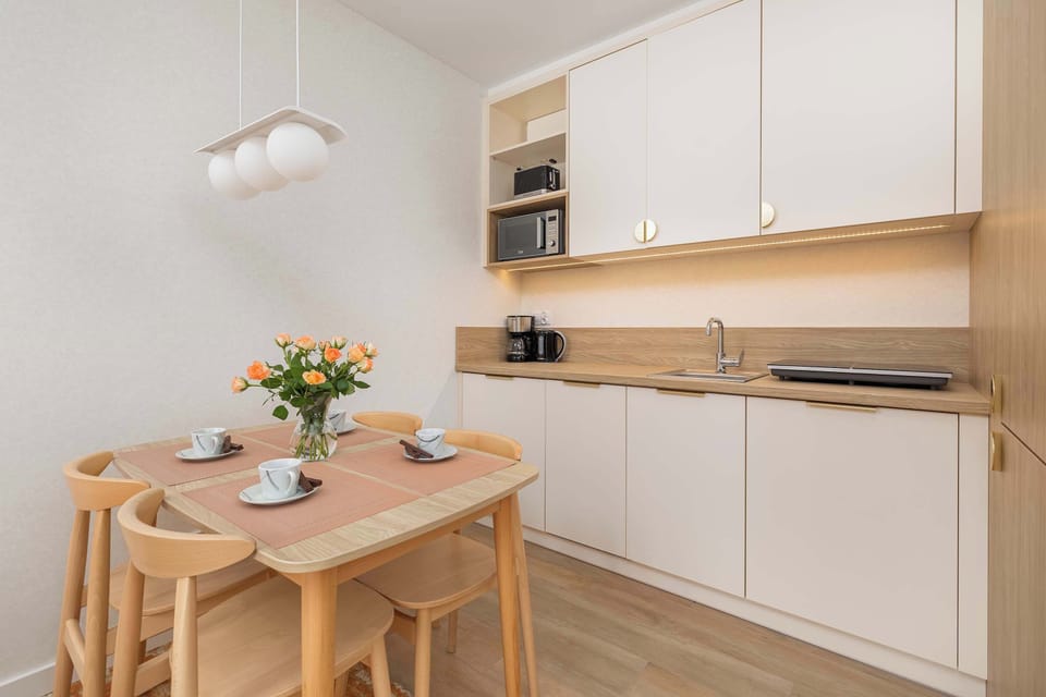 Dining corner next to the kitchenette with a table set for shared meals.