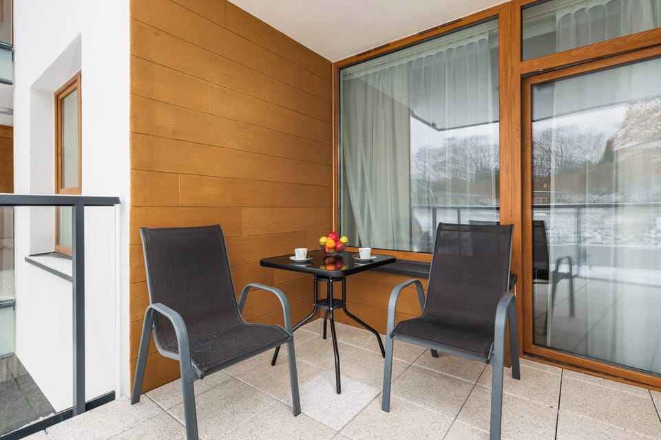 Private balcony with outdoor seating, perfect for enjoying fresh air and relaxing outdoors.