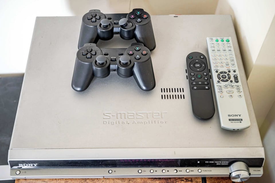 Enjoy a sleek entertainment corner featuring a digital amplifier, remotes, and controllers. Designed for immersive gaming, crisp audio, and laid‑back evenings indoors.
