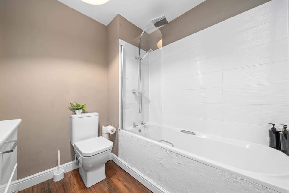 Bathroom Oasis: Relax in a contemporary space with a sleek tub & refreshing rainfall shower!