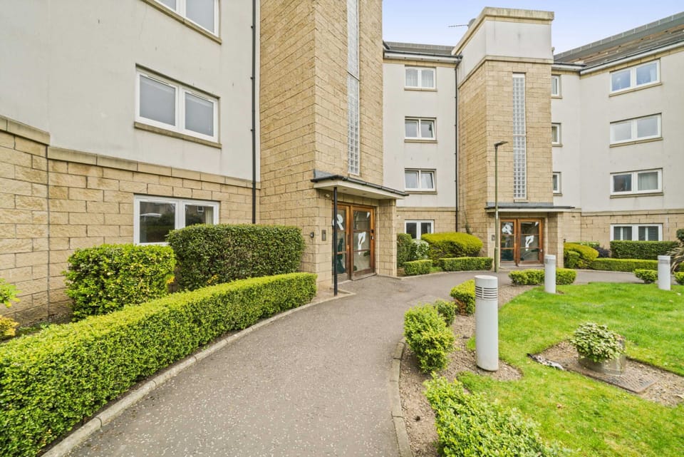 Exterior Entrance: Step into modern elegance surrounded by vibrant gardens in Edinburgh!