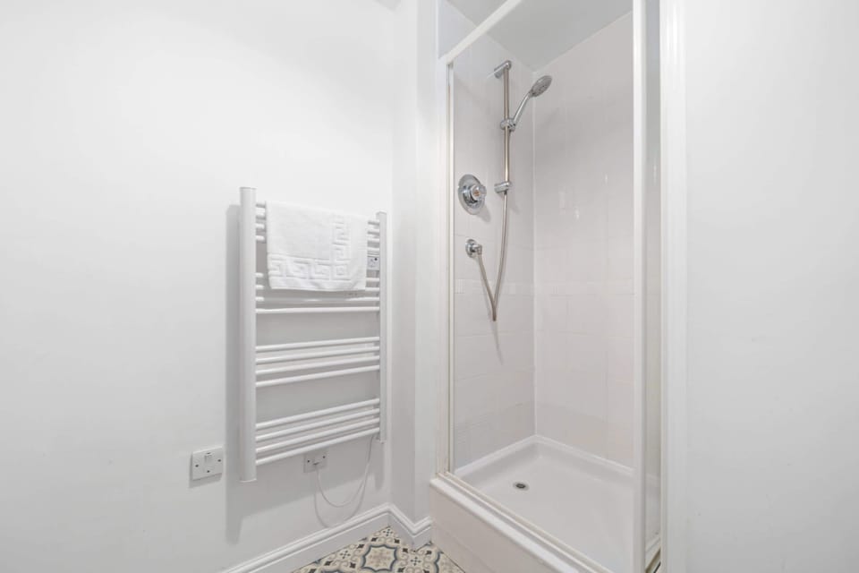 Bathroom: Sleek shower space with stylish tiles for a refreshing retreat after exploring Edinburgh!