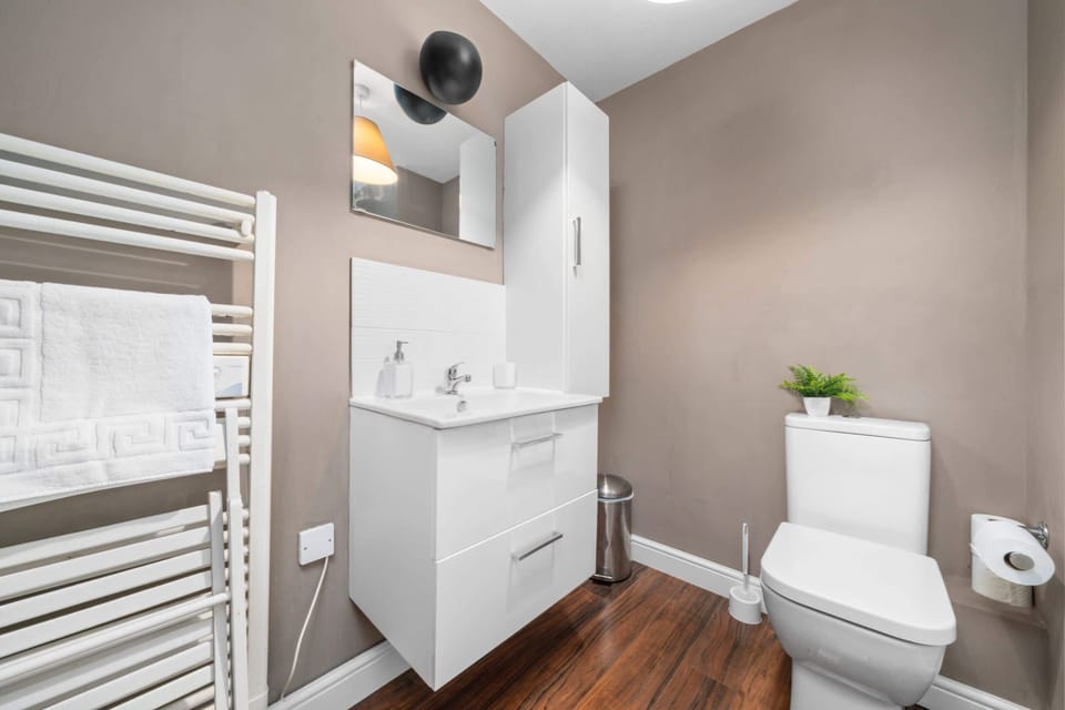 Stylish Bathroom: Enjoy modern amenities in this sleek space with elegant decor and smart storage!