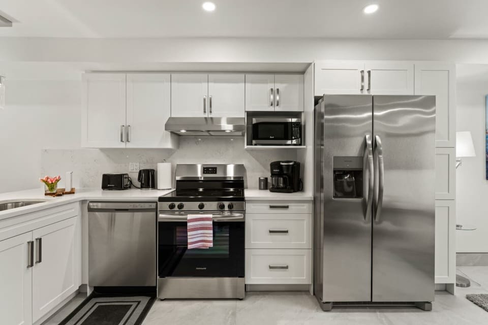 A sleek kitchen concept with all modern amenities included for easy food preparation and clean-up.