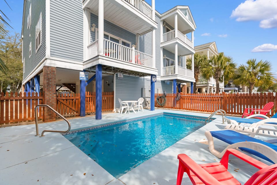 Your private pool awaits with comfortable lounge chairs and dining space, perfect for sunny afternoons and poolside relaxation.