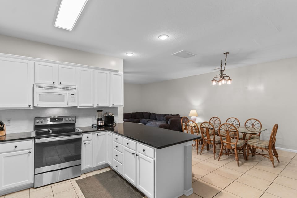 Your spacious kitchen and dining area blend seamlessly, perfect for preparing meals and gathering with loved ones around the welcoming table.