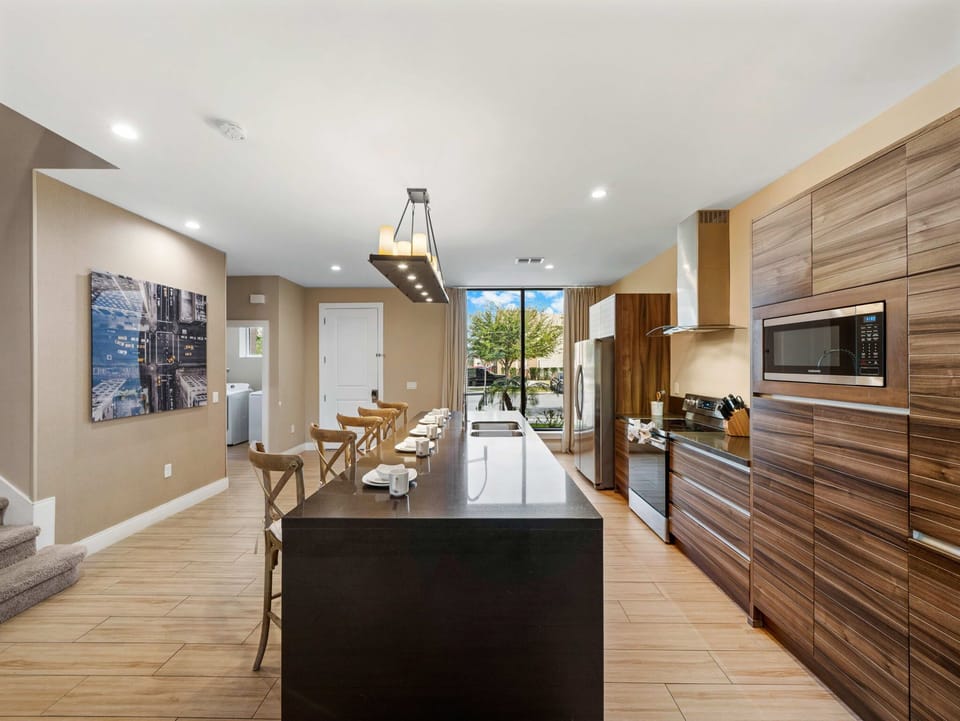 Modern kitchen with a large island and wood-paneled cabinetry for family-friendly meals.