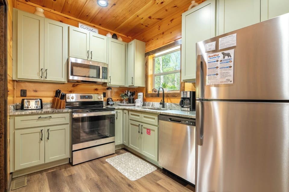 Your fully equipped kitchen features stainless steel appliances, granite countertops, and charming wood beam ceilings for memorable meal preparation.