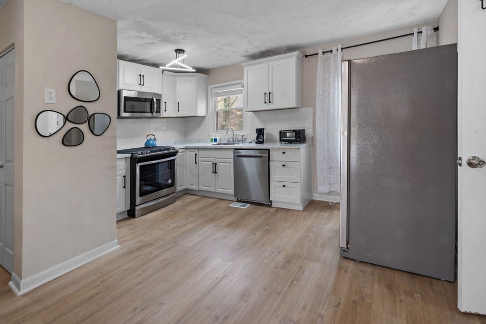 Modern kitchen with stainless steel appliances and plenty of space.