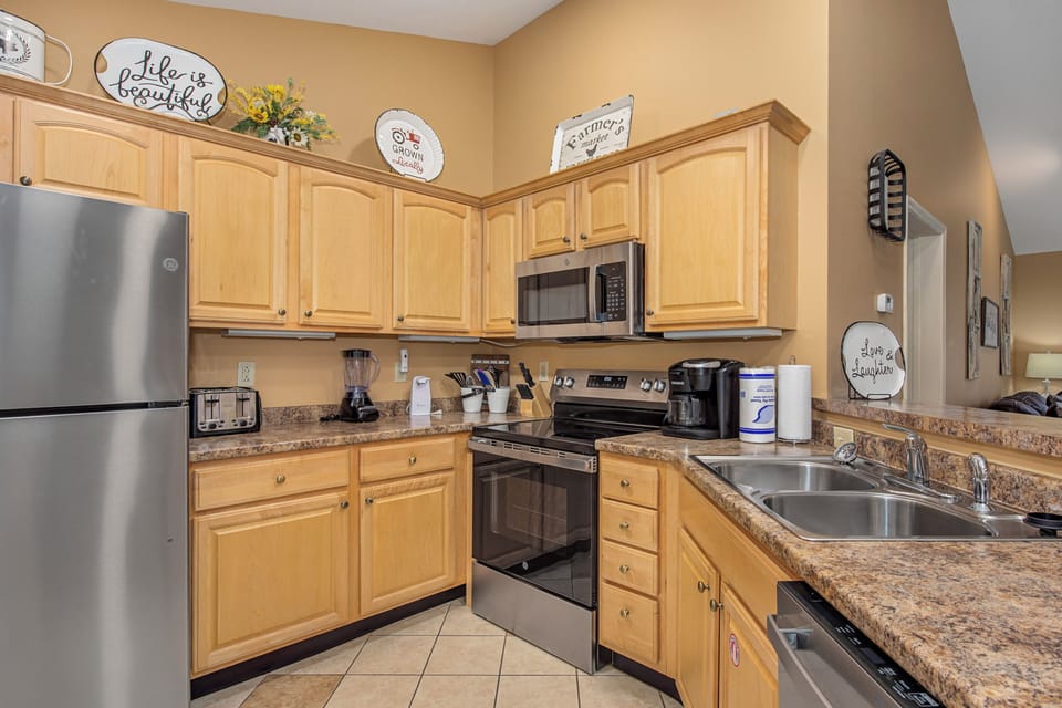 Your fully equipped kitchen features modern appliances and warm wood cabinets, perfect for preparing meals during your stay.