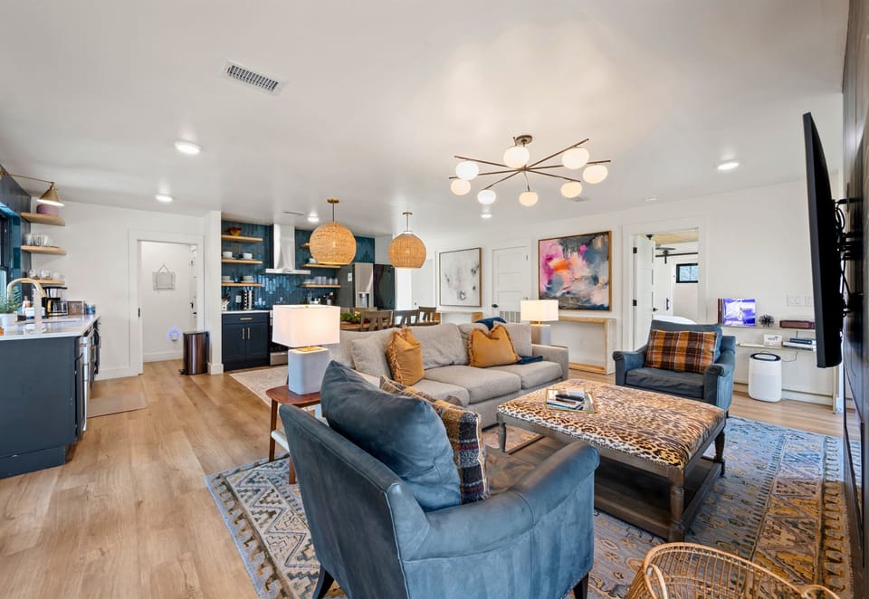 The open flow between the living room and kitchen makes it easy to keep conversations going, creating a seamless space for gathering, cooking, and relaxing all at once.