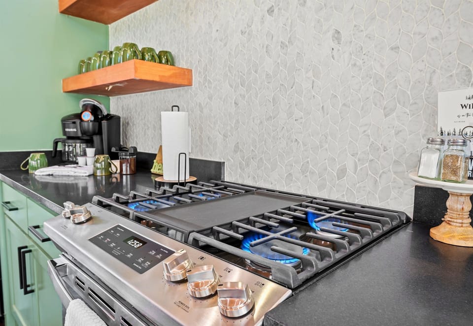 Experience the joy of cooking in a fully-equipped kitchen featuring a modern stainless steel gas stove