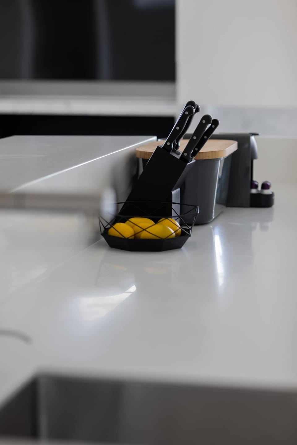A close-up of a coffee machine or kitchen appliance suggests convenience for guests. The sleek design matches the kitchen aesthetic.