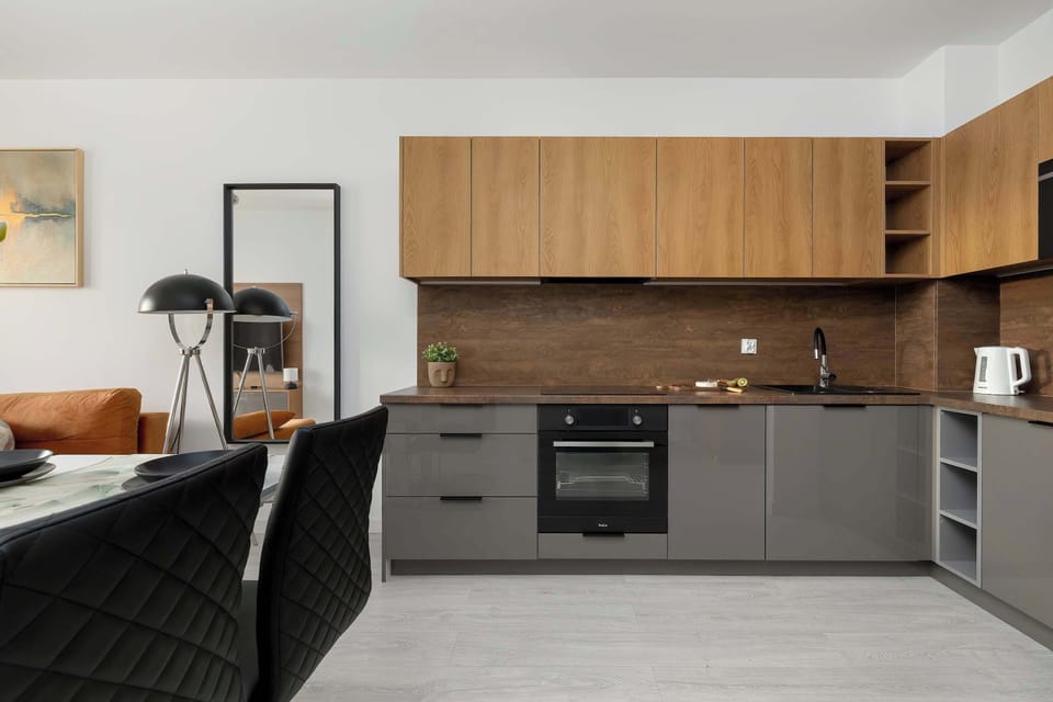 A small countertop setup with a coffee machine and a tray holding cups and supplies.