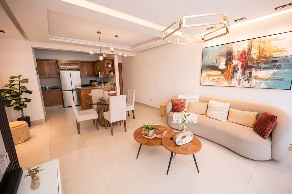 open-concept living with a chic curved sofa, elegant dining, and a gourmet kitchen view.