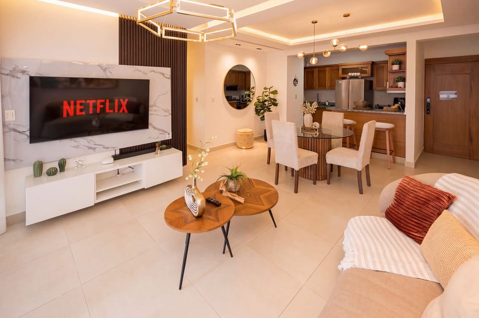 Stay entertained in style with a Netflix-ready living area, marble accents, and chic dining space.
