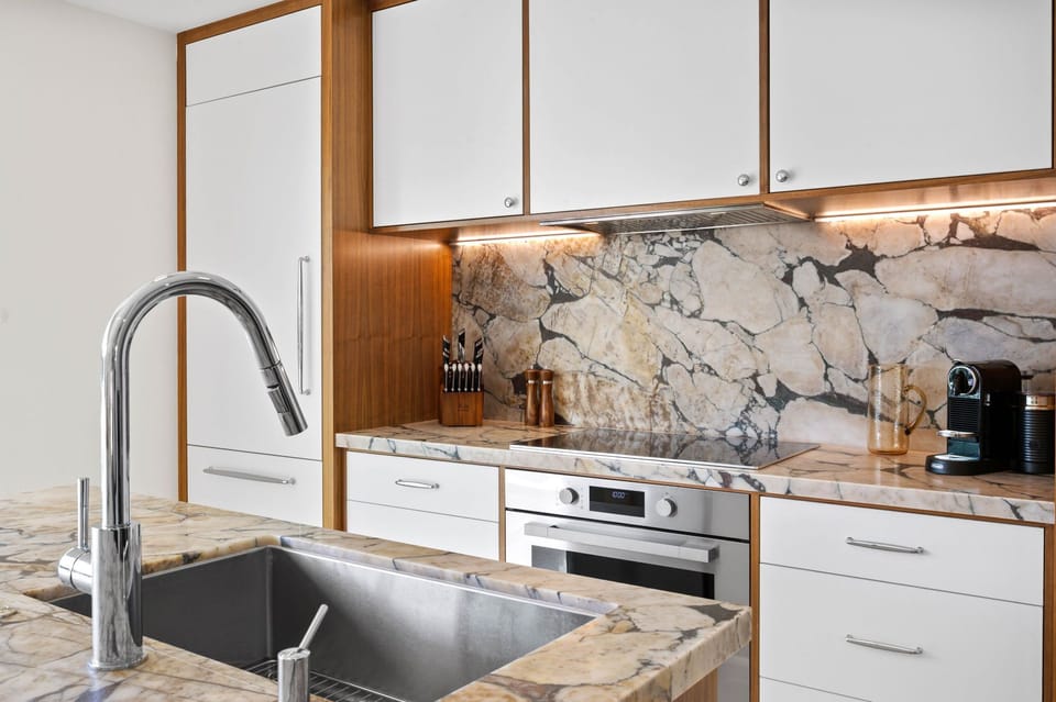 Your fully equipped kitchen blends modern luxury with stunning marble surfaces, perfect for preparing memorable meals during your stay.