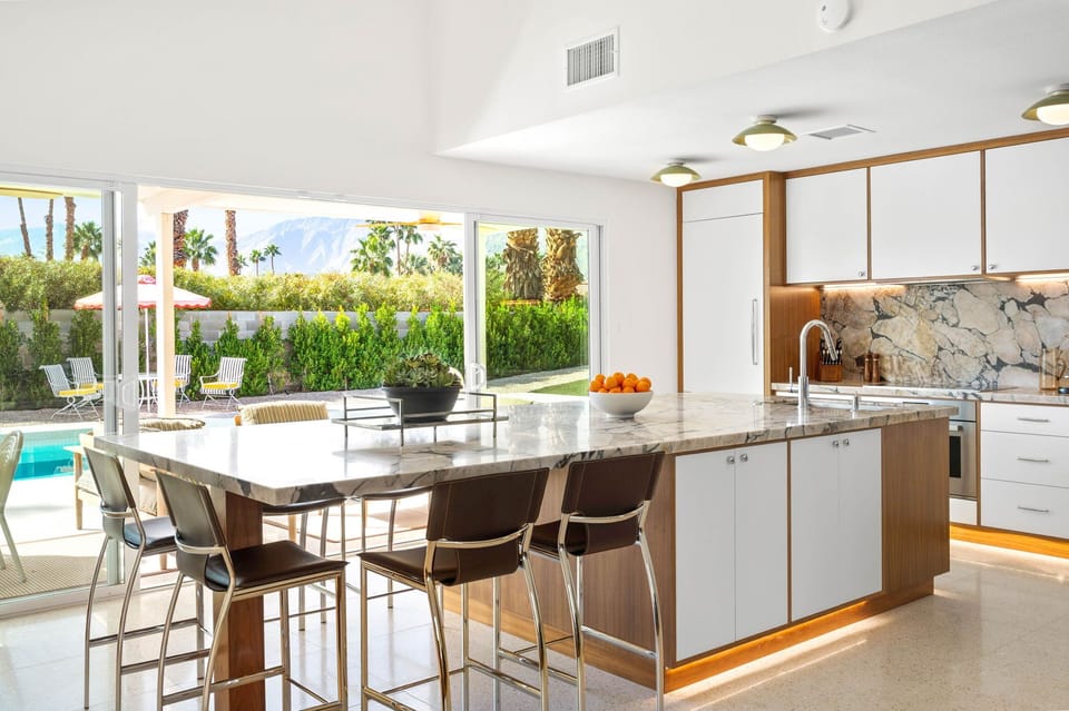 Your gourmet kitchen flows seamlessly to the pool and patio, perfect for entertaining with marble countertops and mountain views.