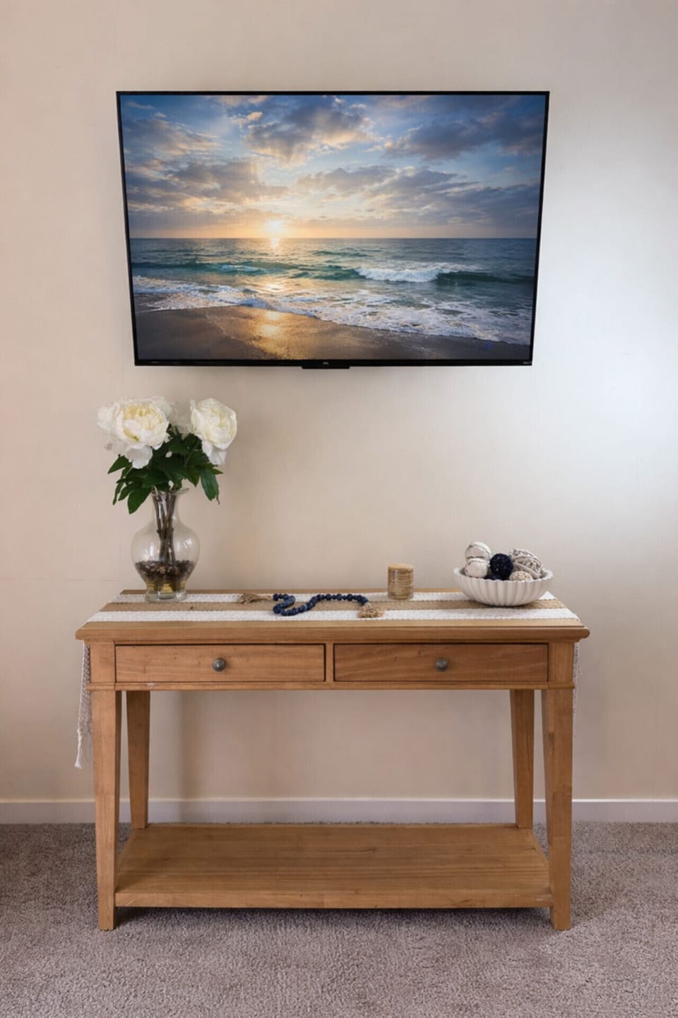 Wall mounted tv setup with a simple console moment below
