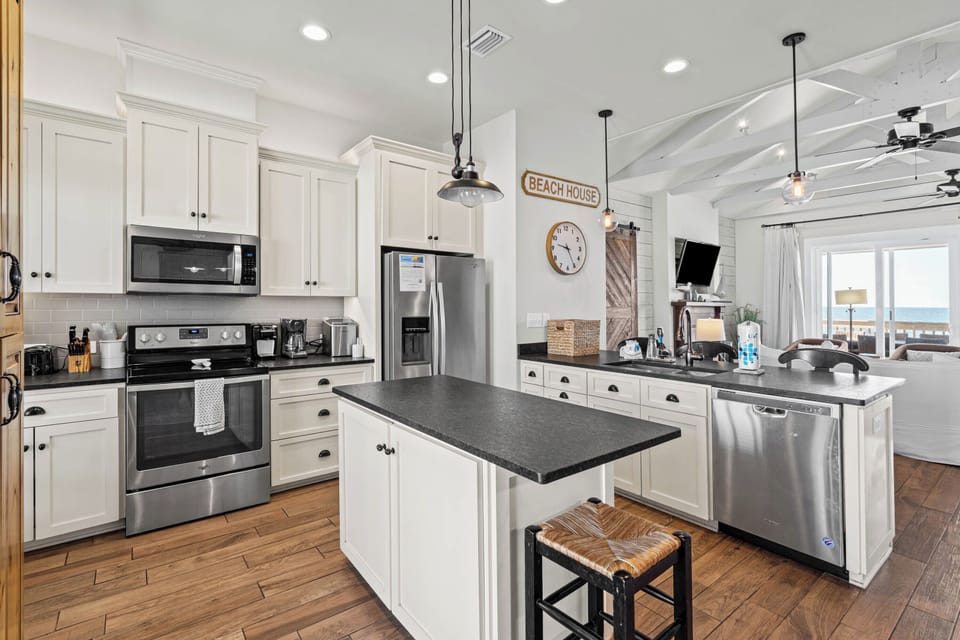 The fully equipped kitchen overlooks the family room & Gulf. Easy & Stunning.