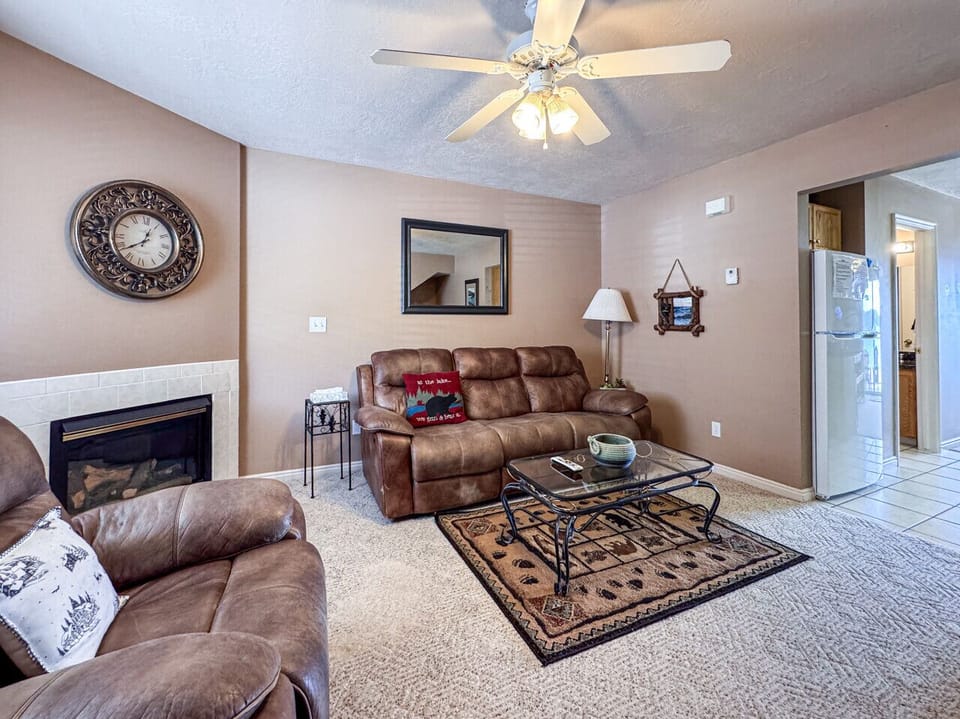 Cozy living room with fireplace, plush seating, and warm, inviting cabin-style décor