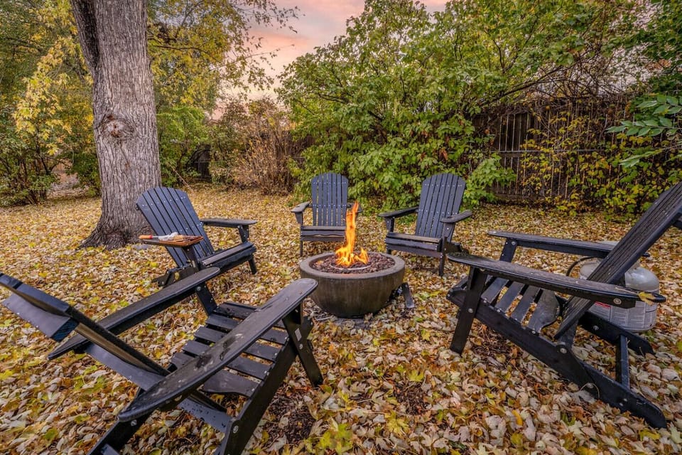 Large, fenced backyard with fire pit, BBQ grill, and outdoor seating