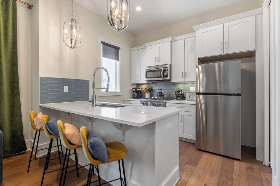 Modern kitchen with full appliances and sleek finishes