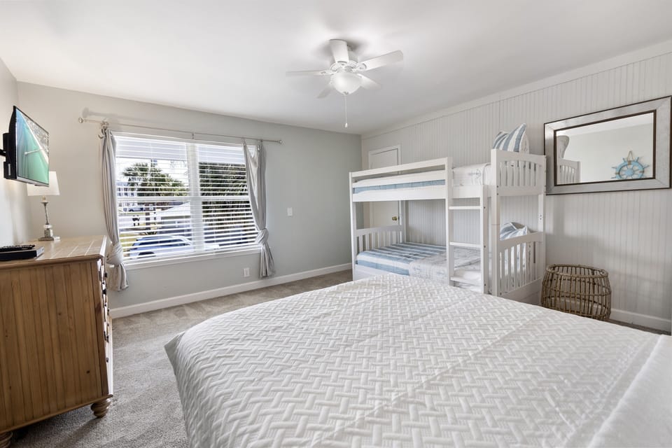 Your coastal bedroom offers comfort for the whole family with fresh linens and a cozy bunk bed for the kids.