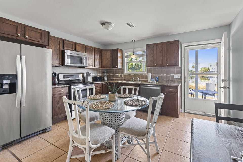 Your fully equipped kitchen awaits with modern appliances and a charming dining nook where you'll enjoy morning coffee with views.