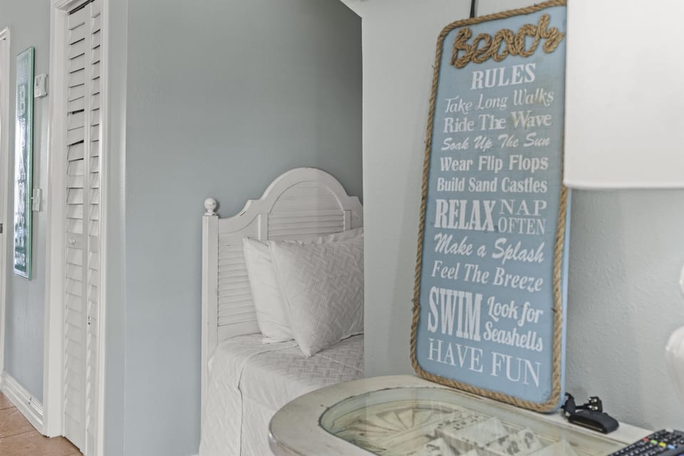 Drift off in your coastal-themed bedroom where soft linens meet charming beach decor, creating the perfect seaside sanctuary.