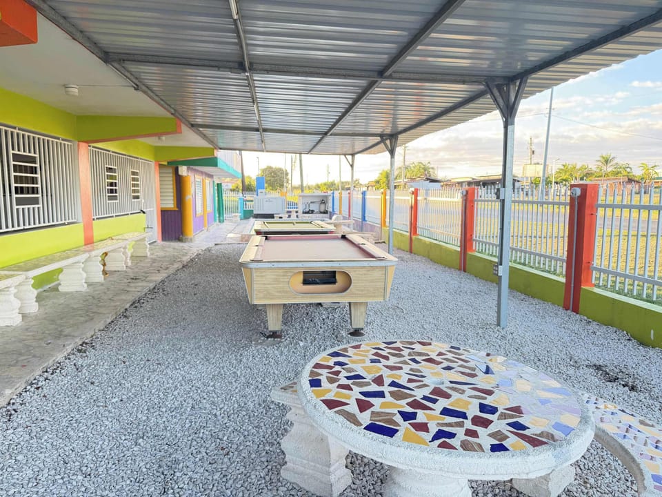 Our expansive outdoor game area offers pool tables and mosaic tables for endless fun.