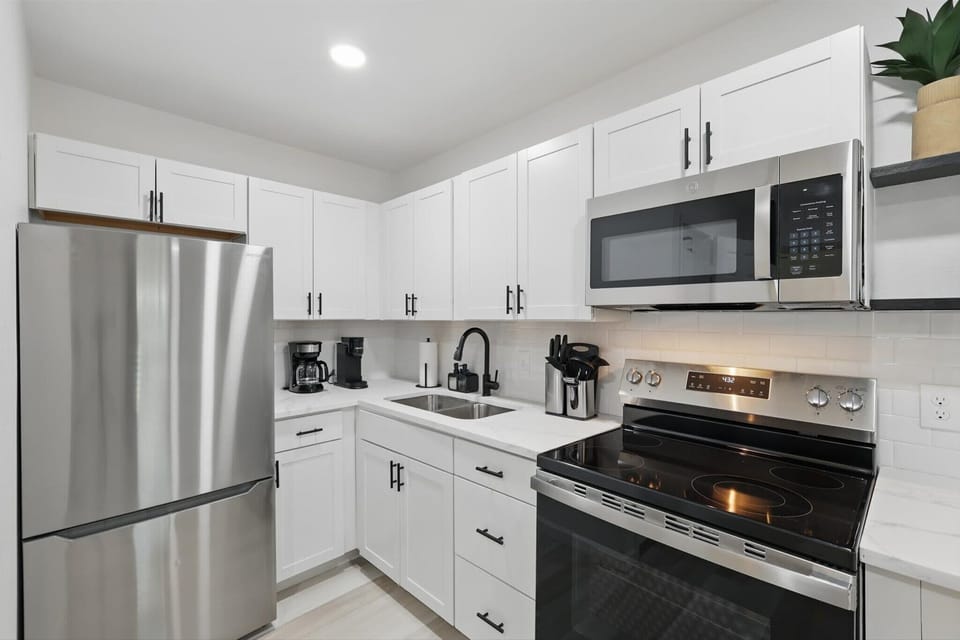“Fully Equipped Kitchen in Unit 3”
From morning coffee to full meals, this modern kitchen has it all — stainless steel appliances, cookware, utensils, and plenty of counter space.