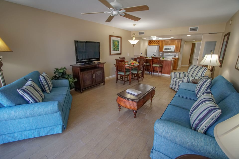 Relax in a spacious living area with stylish furnishings, perfect for entertaining or lounging after a day at the beach.