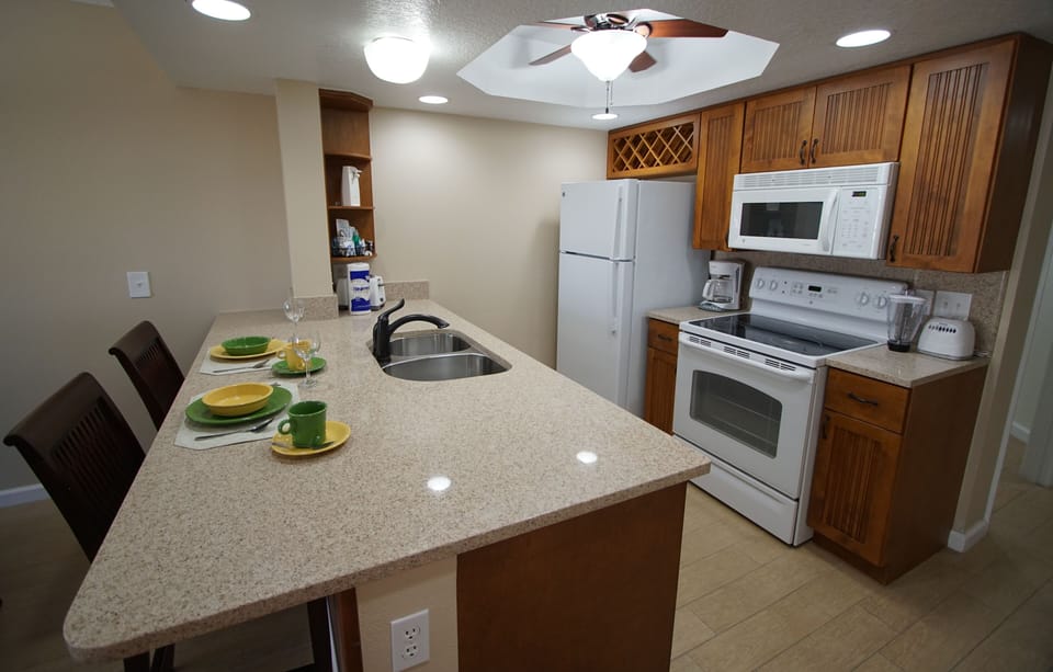 Create culinary delights in this fully equipped kitchen with modern appliances and a spacious countertop.