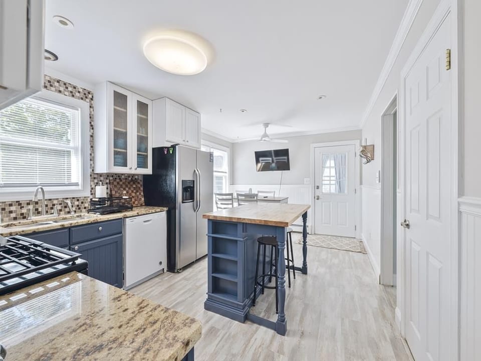 Gather in a stylish kitchen featuring modern appliances and a spacious layout, perfect for meal preparations.