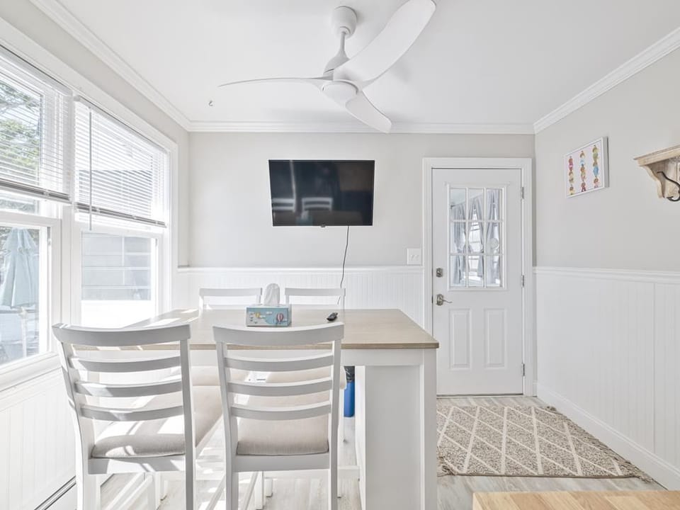 Enjoy casual meals or morning coffee at this bright dining nook, with sunlight filtering through large windows.